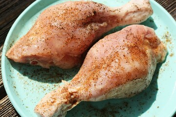 Fresh chicken thighs in spices close up 