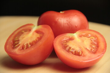 organic tomato slices on wooden background