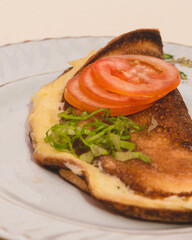 Fluffy omelette with tomatoes and greens