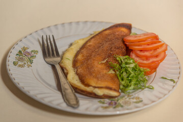 Fluffy omelette with tomatoes and greens