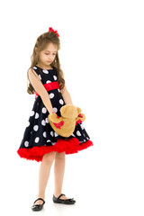 Pretty Long Haired Girl Wearing Polka Dot Dress Posing with Teddy Bear