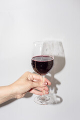 Woman holding a wine glass on white background
