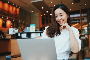 Obraz na płótnie Canvas Happy woman with laptop at cafe.