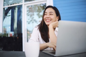 Happy woman with laptop at home 