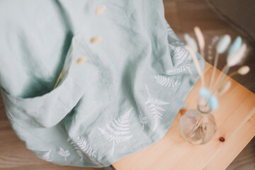 Wild flowers bouquet and linen napkins. Rustic design. Floral composition with linen fabric tablecloth