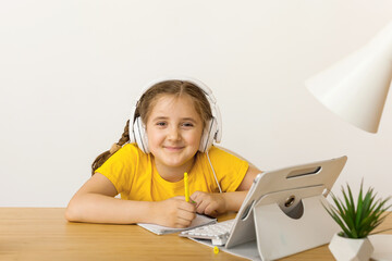 Fototapeta na wymiar girl student wear headphone study online with video call teache