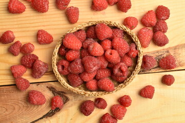 Juicy organic raspberries, close-up, on a wooden table.