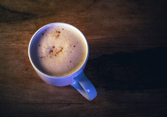 Cup of Coffee Cappuccino on a Wooden Table