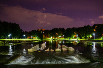 Fototapeta premium Night summer European park with river and promenade