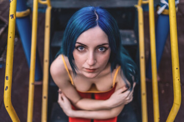 Obraz na płótnie Canvas blue hair and blue eyes pale skin young girl model street photography photoshoot 