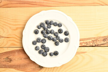 Ripe juicy organic blueberries, close-up, on a  wooden table.