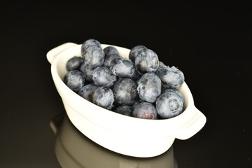 Ripe juicy organic blueberries, close-up, isolated on black.
