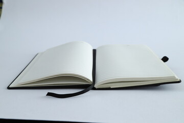 Business concept - sliver laptop with Top view collection of black fly black notebook front, back and white open page, 