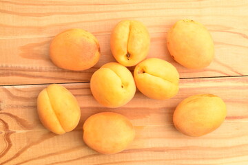 Juicy organic apricots, close-up, on a wooden table.