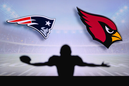 New England Patriots vs. Arizona Cardinals . NFL Game. American Football League match. Silhouette of professional player celebrate touch down. Screen in background.