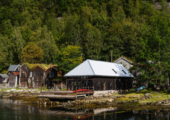 Old wooden buildings by the waters at Geiranger Norway