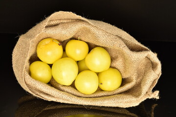 Ripe yellow plum, close-up, isolated on black.