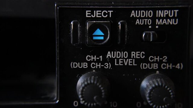 Close up of the eject button of a video tape recorder