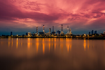 Obraz premium Blurred natural background of the morning sunshine along the river, breathtaking views (cargo ship, oil refinery), boat transportation