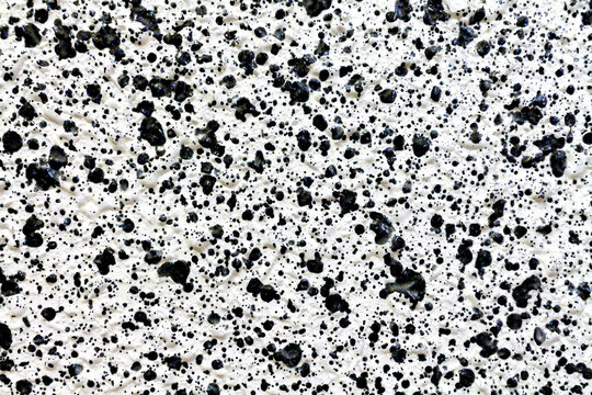 Texture of black drops on white gotele on a wall