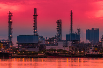 Obraz premium Blurred natural background of the morning sunshine along the river, breathtaking views (cargo ship, oil refinery), boat transportation