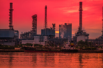 Blurred natural background of the morning sunshine along the river, breathtaking views (cargo ship, oil refinery), boat transportation
