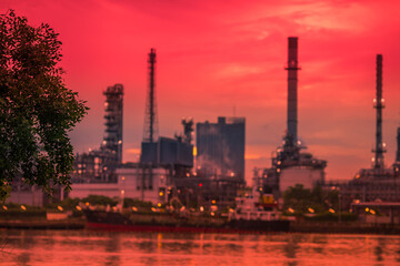 Obraz premium Blurred natural background of the morning sunshine along the river, breathtaking views (cargo ship, oil refinery), boat transportation