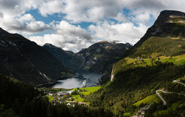 Naklejka na ściany i meble Geiranger fjord seen from the hillside on summer day with one cruise ship in port, Norway