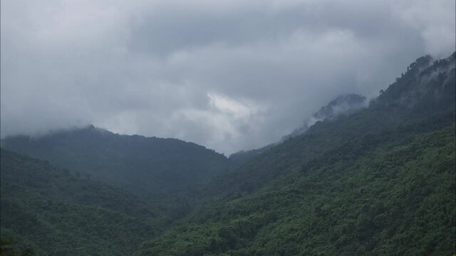 Time-lapse of Cloud Dispersing between two mountains in a Valley with green rain-forest in Manipur, one of the Northeastern states of India shot in 4k