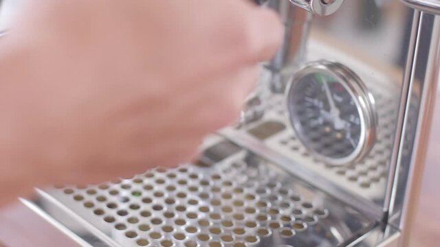 Single espresso shot coffee extraction comes out of espresso machine. 