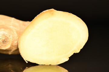 Ripe ginger root, close-up, on a black background.