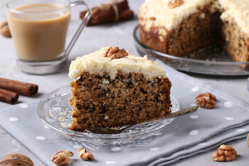 Homemade crumb cake with walnuts and cinnamon in plate on gray concrete background, horizontal format