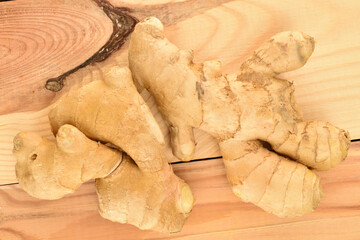 Ripe ginger root, close-up, on a wood table.