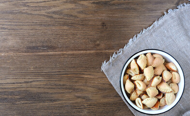 curd cookies on burlap napkin, wooden oak background.