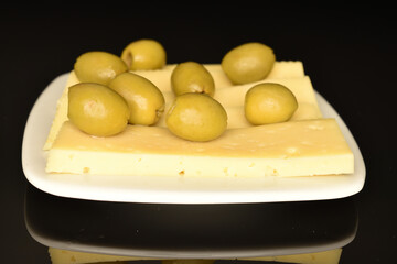 Green pitted olives, close-up, on a black background.