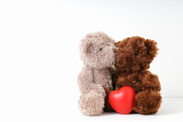 Two teddy bears with red heart on white background. Concept love, valentine day.