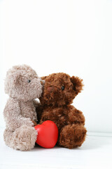 Two teddy bears with red heart on white background. Concept love, valentine day.