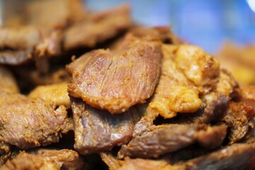 Close up of Fried Pork with fish sauce thai street food market