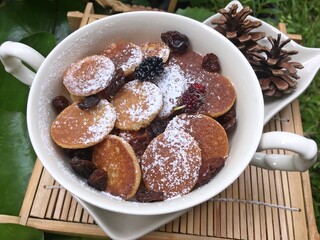 Mini pancake with raisin in the bowl