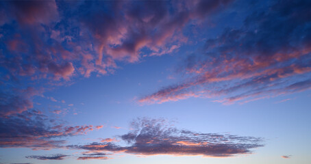 Fototapeta na wymiar beautiful panoramic photo of the blue sky and clouds painted pink by the sunset