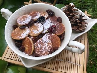 Mini pancake with raisin in the bowl