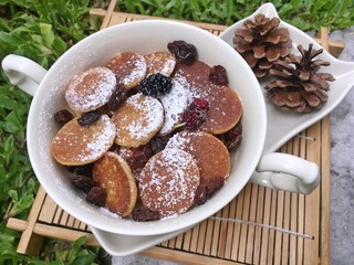 Mini pancake with raisin in the bowl