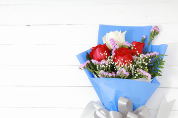 Bouquet of roses on white wood top view flat lay. With copy space, concept valentine day.