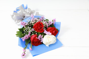 Bouquet of roses on white wood. With copy space, concept valentine day.