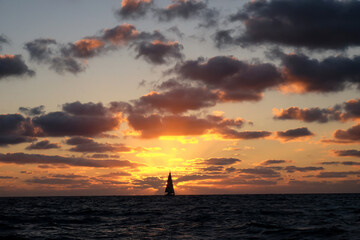 Fototapeta na wymiar Silhouette of a yacht on sunset background