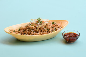 Vegetable Hakka Noodles or Manchurian Hakka or Schezwan Noodles or chow mein is a popular indochinese food served in a bowl. Indian Chinese food, selective focus