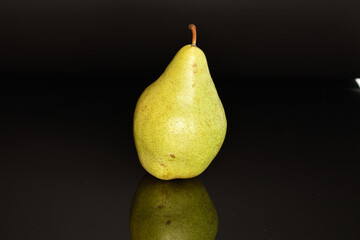 Fototapeta na wymiar Ripe sweet green pears, close-up, isolated on black.