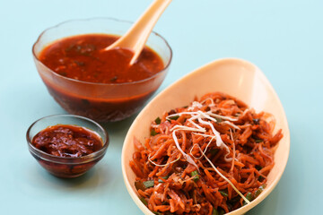 Schezwan Noodles or Manchurian Hakka or vegetable Hakka Noodles or chow mein is a popular indochinese food served in a bowl. Indian Chinese food, selective focus