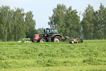 tractor mows green grass