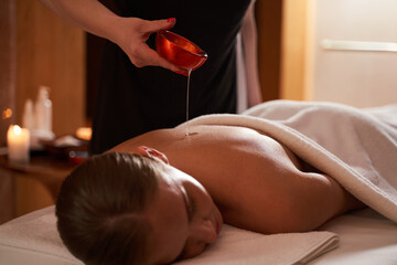 Relaxing massage with herbal oil in spa salon